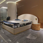 Beige Leather Upholstered Bed with Gold Stainless Steel Elephant Head Accents & Hammered Base Trim